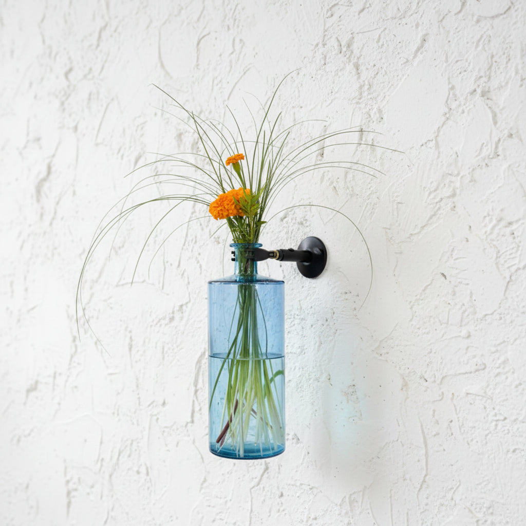 Blue vase with flowers mounted on wall using Curator Wall mount and clamp