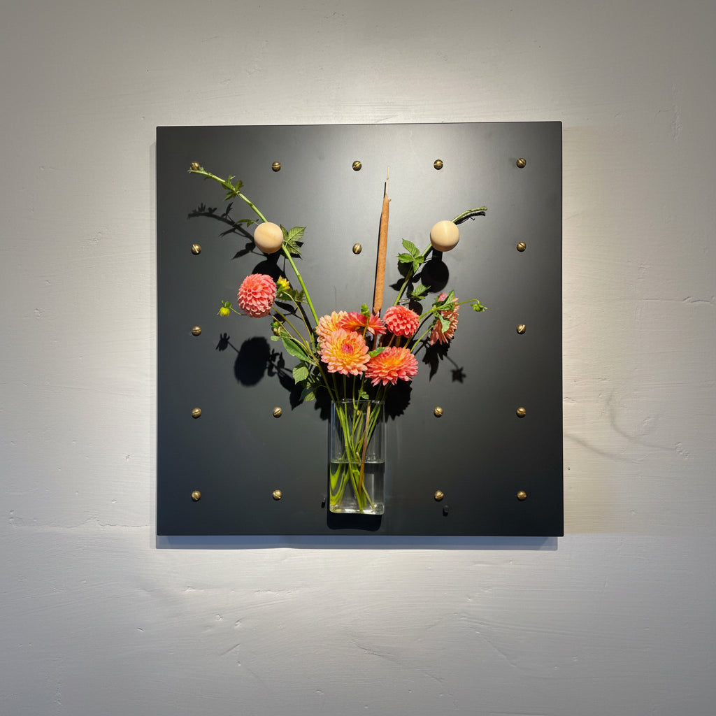 Decorative Curator Wall Panel with flowers and a clock face on a black background