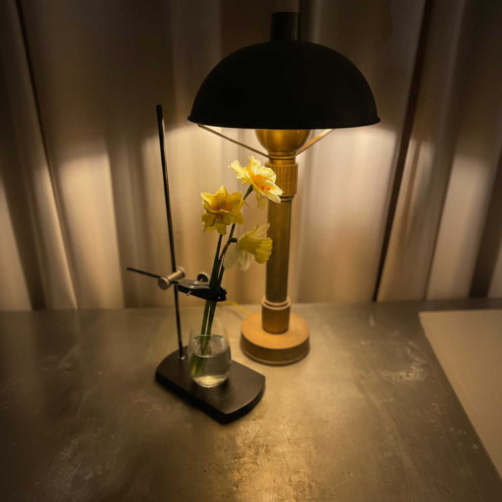 Table lamp with a Curator Table Mount  and flowers on a table